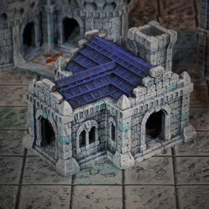 Peut inclure: Une miniature de bâtiment en pierre avec un toit en tuiles bleu, des portes cintrées et de petites fenêtres. Le bâtiment est gris avec des accents bleus, conçu pour les jeux de table ou l'affichage. La structure est faite de blocs de pierre individuels.