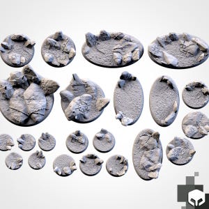 May include: A collection of gray, textured miniature bases in various shapes, including round and oval. Each base features a rocky terrain design with raised stone elements, suitable for tabletop gaming miniatures.