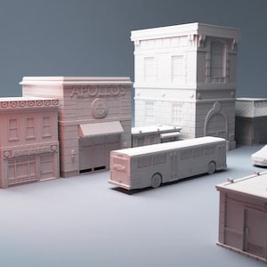 May include: A collection of miniature, off-white buildings and vehicles, including a bus, a car, and several structures labeled "Post Office" and "APOLLOS". The buildings have architectural details like windows, awnings, and decorative elements.