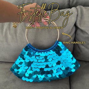 May include: A turquoise sequined handbag with gold ring handles. The bag has a fan-like shape and a blue trim. The text "Estelle Bag" is written in gold cursive script above the bag. The text "PDF + PHOTOS & VIDEO" is also visible.