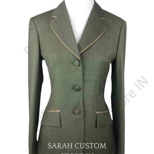 Pode incluir: Blazer verde oliva com corte sob medida, com lapela entalhada e fecho de três botões. O blazer tem dois bolsos frontais e acabamento dourado ao longo da lapela e dos bolsos. O texto "SARAH CUSTOM STORE IN" está impresso na parte inferior do blazer.