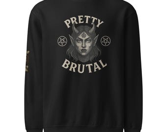 May include: Black sweatshirt with the words "PRETTY BRUTAL" in a stylized font. The graphic features a demonic woman with horns, a pentagram on her forehead, and two pentagrams on either side of her. The sleeve has text that reads "UP TO REAL".