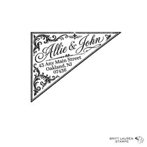 May include: A triangular black and white rubber stamp design featuring the names Allie & John in a cursive script, followed by the address 43 Any Main Street, Oakland, NJ 07436. The text is framed by ornate, swirling filigree scrollwork patterns.