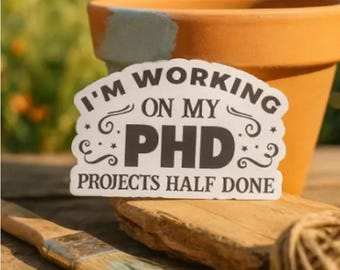 PHD Projects Half Done Vinyl Sticker – Funny Matte Waterproof Crafty Humor Decal for Planners, Laptops, Crafters & Creative Spirits