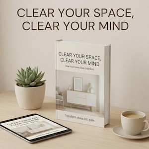 May include: A white book titled Clear Your Space, Clear Your Mind with a matching tablet, a small green succulent in a beige pot, and a white coffee cup on a saucer. The book cover features an interior room scene and the text Transform chaos into calm.