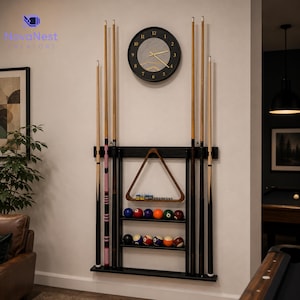 May include: A black wall-mounted pool cue rack featuring storage for six cues, two shelves for billiard balls, and a wooden triangle rack. Above the rack hangs a round black wall clock with a grey marble-patterned face and gold hands.