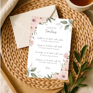May include: A prayer card for teachers with floral accents. The card features the text "A prayer for Teachers" and a prayer. The card is on a woven placemat with a cup of tea and an envelope.