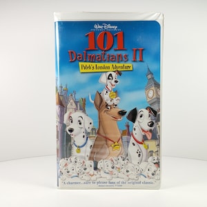 May include: A VHS tape for the Disney animated film "101 Dalmatians II: Patch's London Adventure." The cover features cartoon dalmatian dogs, the title text, and a London cityscape background. The tape is in a white plastic case.