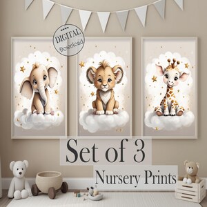 May include: A set of three framed nursery prints. Each print features a cartoon animal: an elephant, a lion cub, and a giraffe, all sitting on clouds with gold stars. The text reads "DIGITAL Download" and "Set of 3 Nursery Prints".