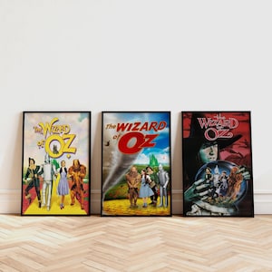 May include: Three framed movie posters for "The Wizard of Oz" are displayed. The posters feature colorful illustrations of characters and scenes from the classic film, with the title prominently displayed in bold lettering.
