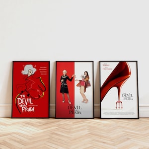 Könnte beinhalten: Drei gerahmte Filmplakate für "Der Teufel trägt Prada" werden gezeigt. Die Poster zeigen kräftige rote und weiße Hintergründe mit stilisierten Illustrationen und dem Filmtitel. Die Poster sind in schwarzen Rahmen.