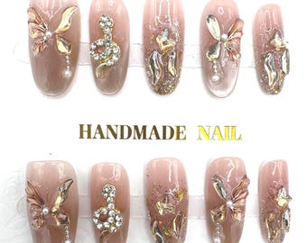Uñas postizas - Hechas a mano / Talla S / Ovaladas medianas / Llenas de pedrería / Mariposa / Brillantina / Doradas