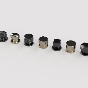 May include: A selection of ten cabinet knobs in diverse shapes and finishes. The knobs feature designs such as cylindrical, faceted, and spherical, with colours including silver, gold, and black.