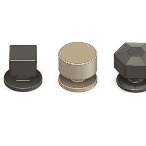 May include: A selection of seven cabinet knobs in different styles and colours. The knobs feature designs such as a stacked cylinder, fluted, square, smooth cylinder, faceted, heart-shaped, and rounded. Each knob has a base, suitable for furniture.