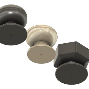 May include: A selection of cabinet knobs in different shapes and finishes. The knobs include a dark grey sphere, a light beige sphere, a dark grey faceted knob, and a gold cylindrical knob. Each knob has a circular base.