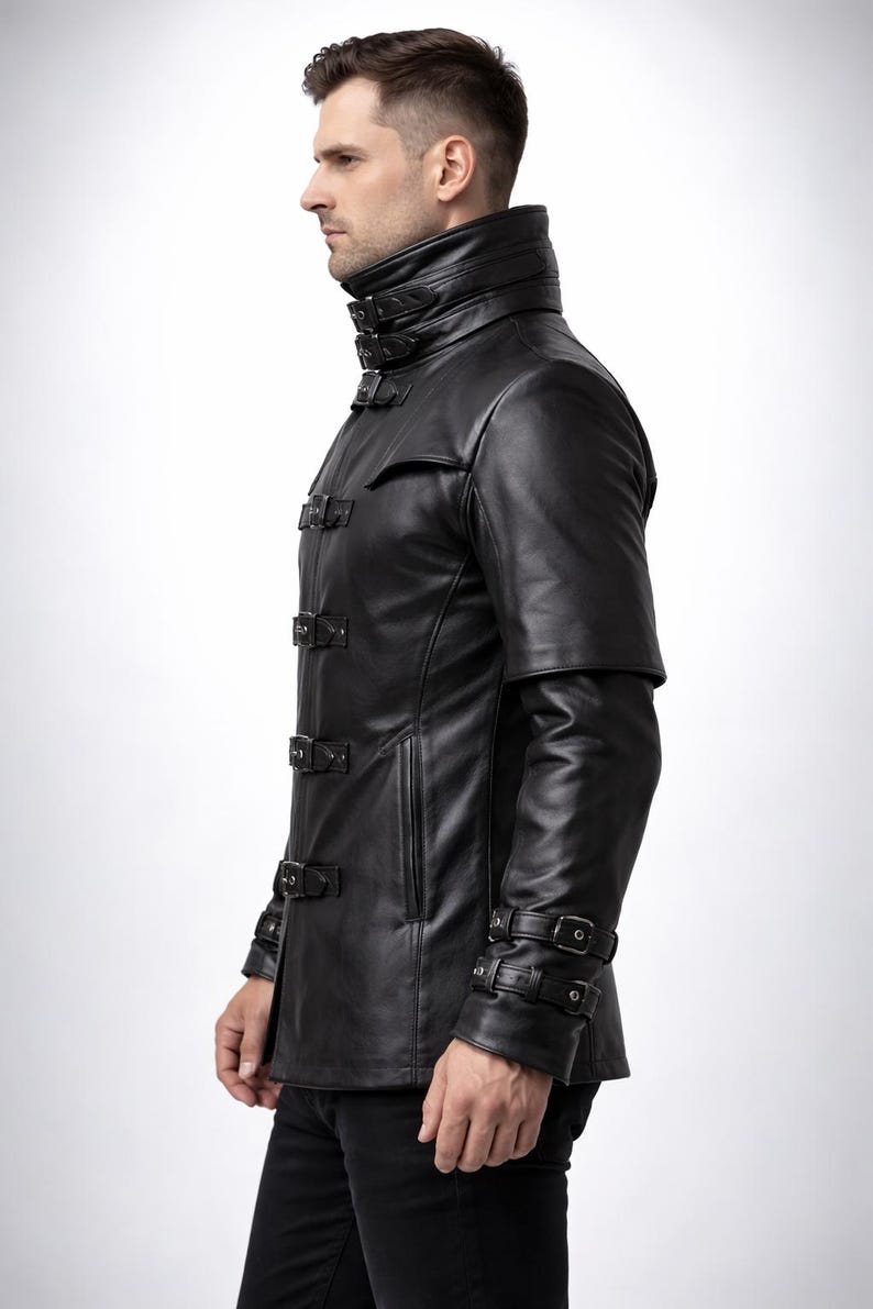 May include: Black leather jacket with a high collar and multiple buckle closures. The jacket features a unique design with short sleeves and a tailored fit. A stylish outerwear piece.