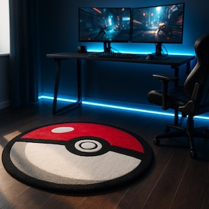 May include: A circular rug with a red and white Poké Ball design and a black border. The rug is placed on a wooden floor in a room with a gaming setup, including dual monitors and a black chair.