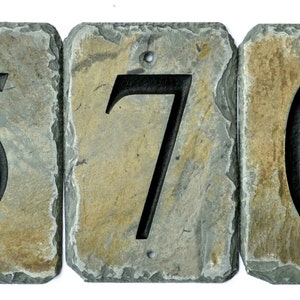 May include: Three slate house numbers, 570, with black painted numbers. The numbers are attached together with a rough, rustic look.