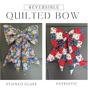 May include: A reversible quilted bow featuring two distinct patterns. One side displays a colorful floral stained glass print, while the other side shows a red, white, and blue patriotic patchwork design with small American flag motifs.