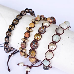 May include: Four beaded bracelets with brown cord and various colored beads. The bracelets are made with natural stones and pearls.