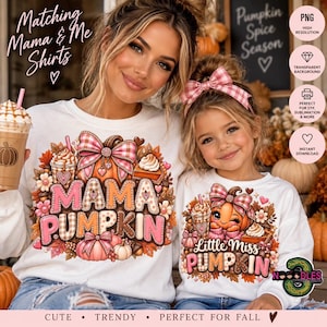 May include: Two white long-sleeve shirts featuring a graphic print of pumpkins, autumn leaves, and coffee cups. The larger shirt displays the text Mama Pumpkin, while the smaller shirt displays the text Little Miss Pumpkin, both in pink and brown.