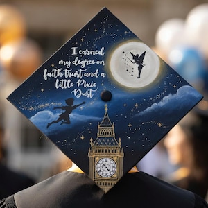 May include: A graduation cap with a whimsical design featuring Peter Pan, Tinkerbell, and Big Ben against a starry night sky. The cap is painted with the words "I earned my degree on faith, trust, and a little pixie dust."