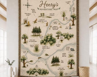 May include: A woven throw blanket featuring a map of the Hundred Acre Wood with the text Henry's Adventure Map. The cream-colored fabric displays illustrations of trees, rivers, and characters with labels like Pooh Bear's House and Piglet's House.