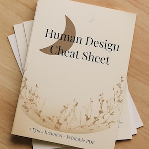 May include: A pile of cream-coloured paper sheets with the title "Human Design Cheat Sheet" in black text, and a crescent moon graphic. The bottom of the sheet reads "5 Types Included - Printable PDF".