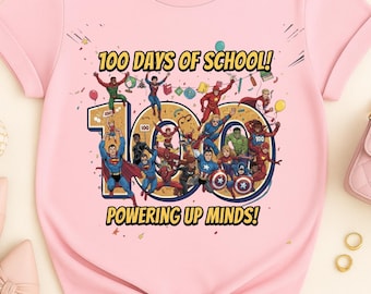 May include: Pink t-shirt featuring a graphic with the text "100 DAYS OF SCHOOL!" and "POWERING UP MINDS!". The graphic includes illustrations of superheroes and the number 100.