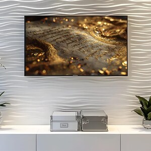 May include: A flat-screen television displays a close-up of an antique document with gold accents. Below, two silver storage boxes sit on a white cabinet. The wall behind the TV has a textured, wave-like pattern.