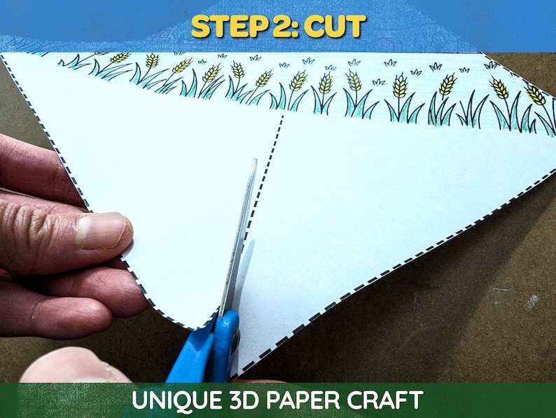 May include: A close-up of a white paper craft being cut with blue scissors. The paper has a decorative border with wheat and grass illustrations. The text "STEP 2: CUT" is at the top, and "UNIQUE 3D PAPER CRAFT" is at the bottom.