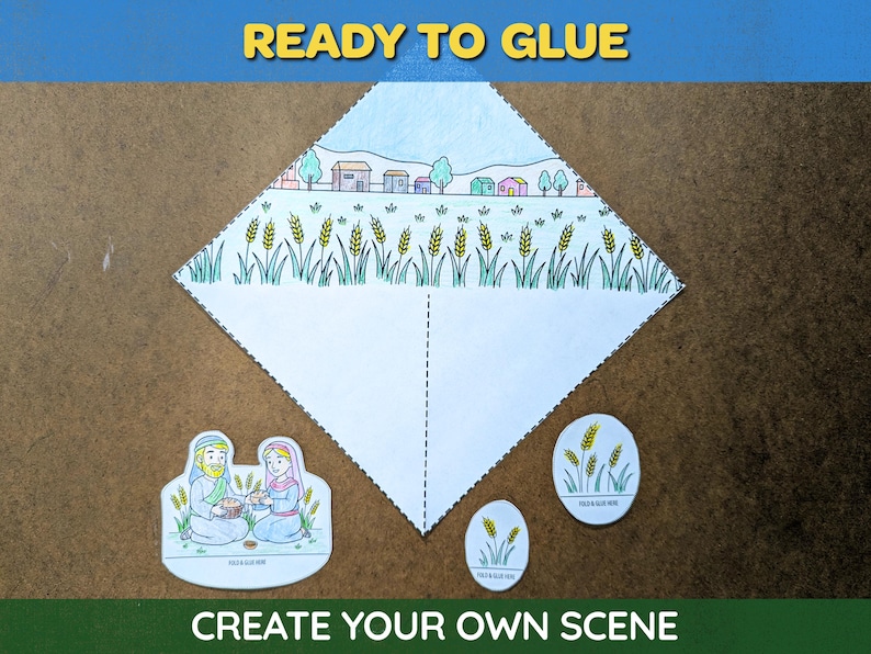 May include: A craft kit with the text "READY TO GLUE" and "CREATE YOUR OWN SCENE". The kit includes a diamond-shaped paper with a landscape scene, and cut-out figures. The scene features a village and wheat.