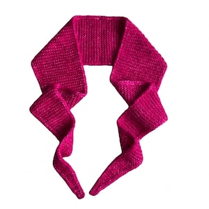 May include: A vibrant magenta scarf featuring a fine, consistent knit texture. The accessory is shaped with a wide, flat central section that tapers into two long, flowing ends, creating a distinct, angular silhouette against a plain background.
