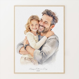 May include: Watercolor portrait of a father and child embracing, both smiling. The artwork is framed in a light wood tone. The text "Happy Fathers Day 2026" is written at the bottom of the image.