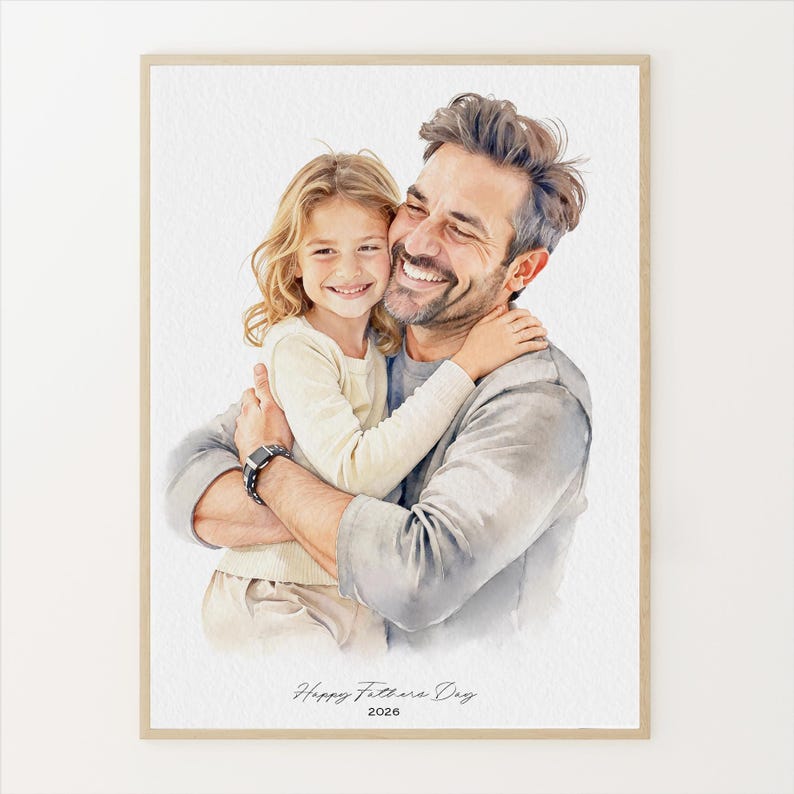 May include: Watercolor portrait of a father and child embracing, both smiling. The artwork is framed in a light wood tone. The text "Happy Fathers Day 2026" is written at the bottom of the image.