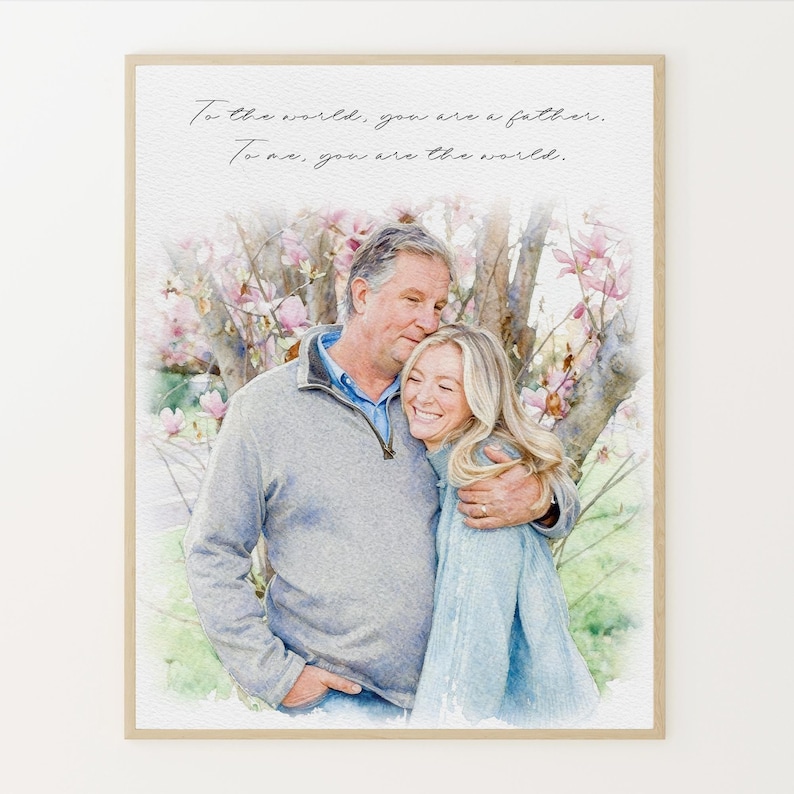 May include: Watercolor-style print featuring a man and woman embracing, set against a backdrop of a flowering tree. The print includes the text: "To the world, you are a father. To us, you are the world."