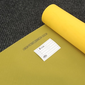 May include: A roll of bright yellow screen printing mesh fabric. The material features printed text reading 1041M PET80T/200MESH-165CM and a small white rectangular label with the number 200 printed on it, indicating the mesh count specifications.