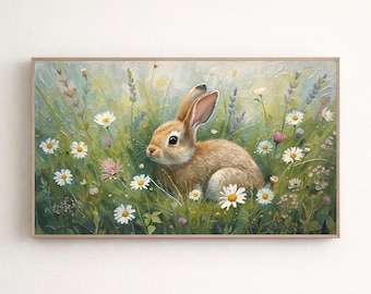 Puede incluir: Pintura enmarcada de un conejo marrón entre flores silvestres. La obra utiliza una paleta suave de verdes, amarillos y blancos, con toques de morado. El conejo es el foco, rodeado de margaritas y hierba alta.