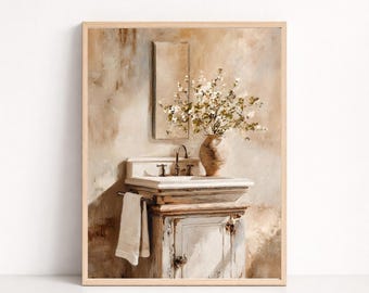 May include: A framed wall art print depicting a bathroom vanity with a white sink, a metal faucet, and a beige ceramic vase filled with white flowers. A white towel hangs from a bar on the side of the cabinet, and a rectangular mirror is mounted above.