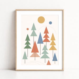 May include: A framed art print featuring a minimalist design of colorful geometric trees. The trees are in shades of green, blue, orange, and yellow, set against a cream background with a yellow sun and blue dot. The artwork is in a wooden frame.