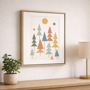 May include: A framed art print featuring a minimalist forest scene with geometric trees in shades of green, orange, blue, and yellow. A yellow sun and blue dot are in the sky. The artwork is displayed on a light-colored wall.