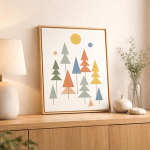 May include: A framed art print featuring a minimalist forest scene with colorful triangular trees in shades of green, orange, blue, and yellow. A yellow sun and blue dot are in the sky. The artwork is displayed on a wooden cabinet.