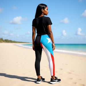 May include: A woman wearing a black t-shirt and black leggings with a Puerto Rican flag design. The leggings feature a black panel on one side and a blue, white, and red panel with a white star on the other. Black sneakers complete the outfit.