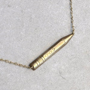 Brass pencil charm on a 17 inch choker chain that can be longer or shorter upon request. Great gift for teachers, crafters, or artists.