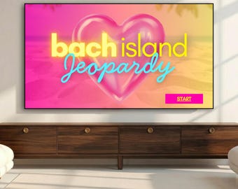 May include: A digital screen displays a vibrant graphic with a large, glossy pink heart at the centre. The text reads "bach island Jeopardy" in yellow and light blue, with a small pink button labelled "START" in the bottom right corner.