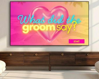May include: A digital screen displays a vibrant pink and yellow gradient background featuring a large, glossy, three-dimensional pink heart at the centre. The text reads What did the groom say? in cyan and yellow, with a pink button labelled START.