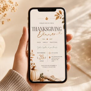 May include: A smartphone displaying a digital Thanksgiving dinner invitation with autumn leaf illustrations, a small pumpkin graphic, and text detailing the event date of November 26, 2026, time, location, and RSVP information in a neutral color palette.