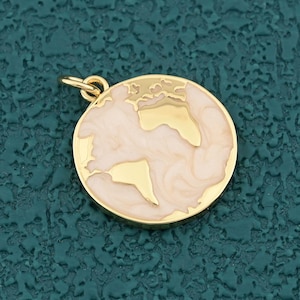 May include: A gold-coloured round pendant with a world map design. The continents are gold, and the oceans are a creamy white colour. The pendant has a small loop at the top for attaching to a chain or bracelet.