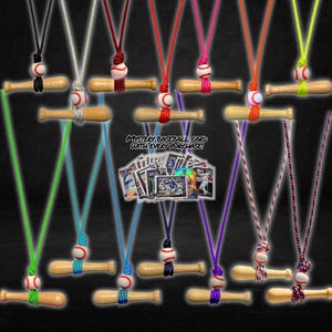 May include: Baseball bat pendant necklaces with various colored cords. Each necklace features a small wooden bat and a baseball. The image includes the text "Lucky Bat Co." and "Mystery Baseball Card With Every Purchase!"