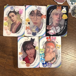 May include: Five rectangular photo cards featuring portraits of people, each surrounded by a decorative border with the text "my bias" and "supports gay rights" or "supports trans rights". The cards are adorned with cute animal-shaped embellishments.